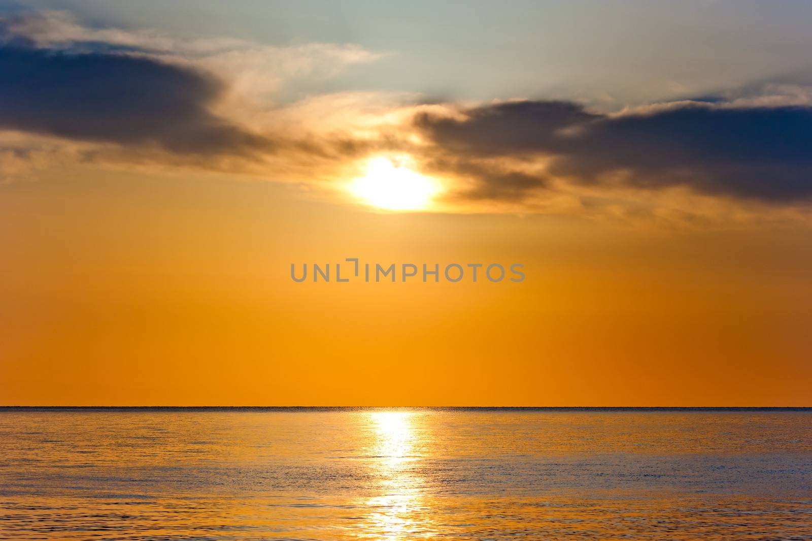 sunset in orange tones over a calm sea