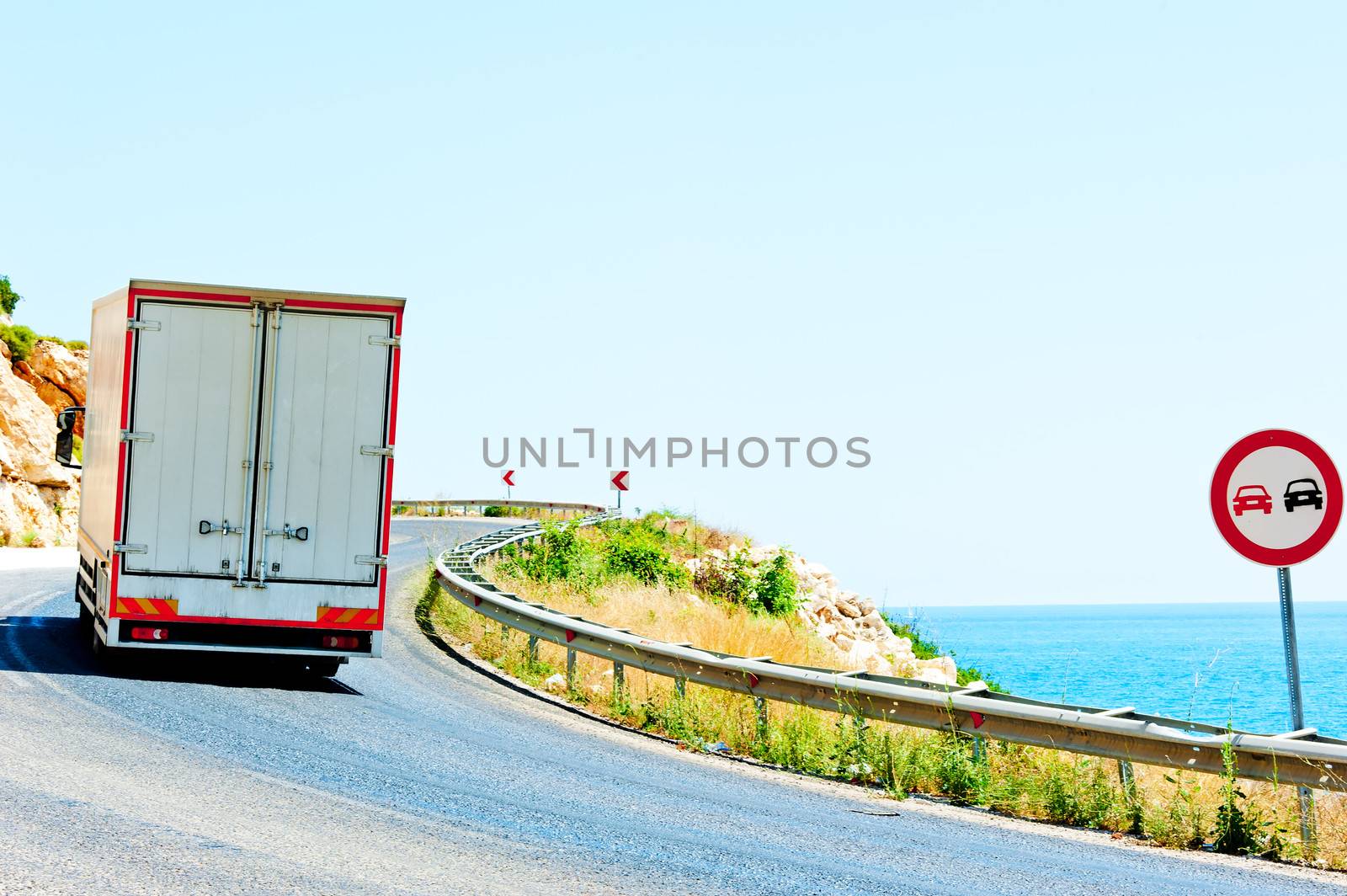 truck on a dangerous road along the sea