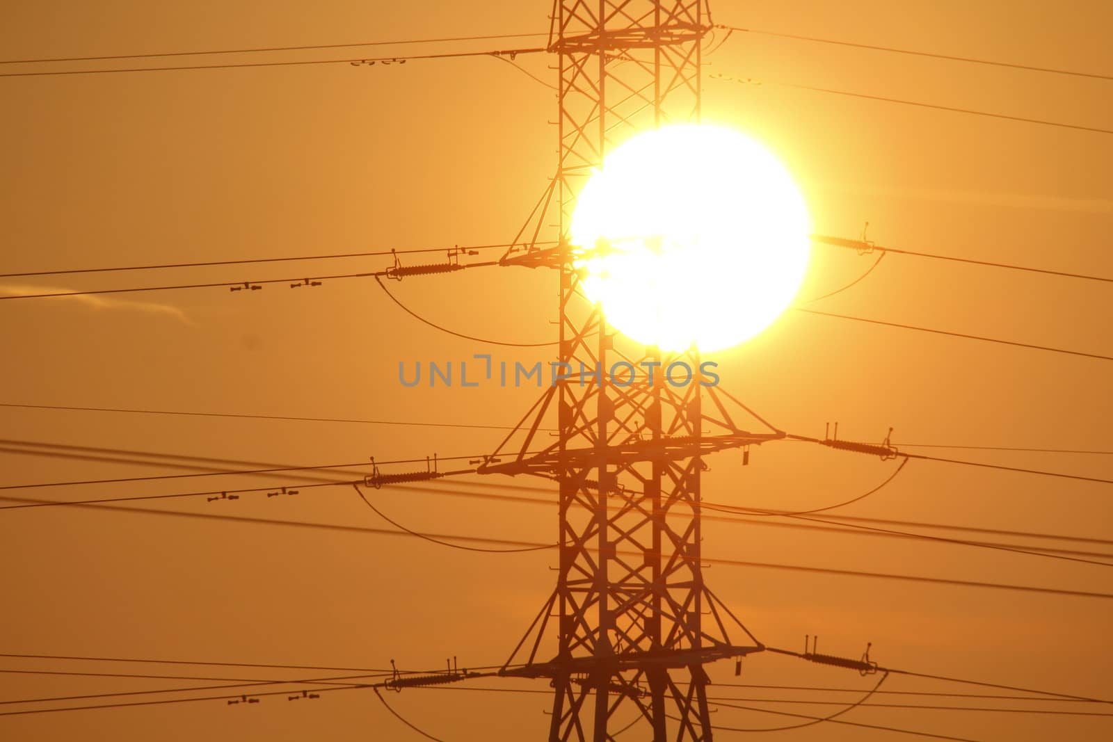 The power lines with the sun in the background