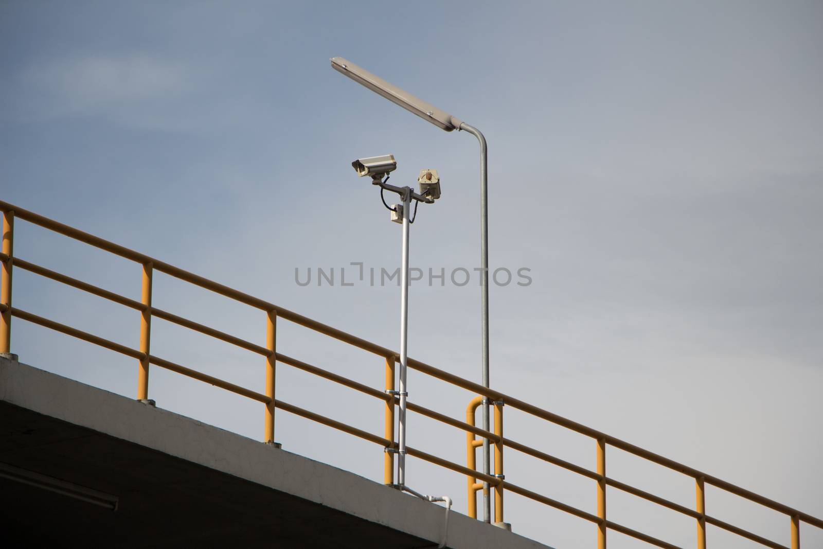 CCTV security cams at carpark and blue sky.