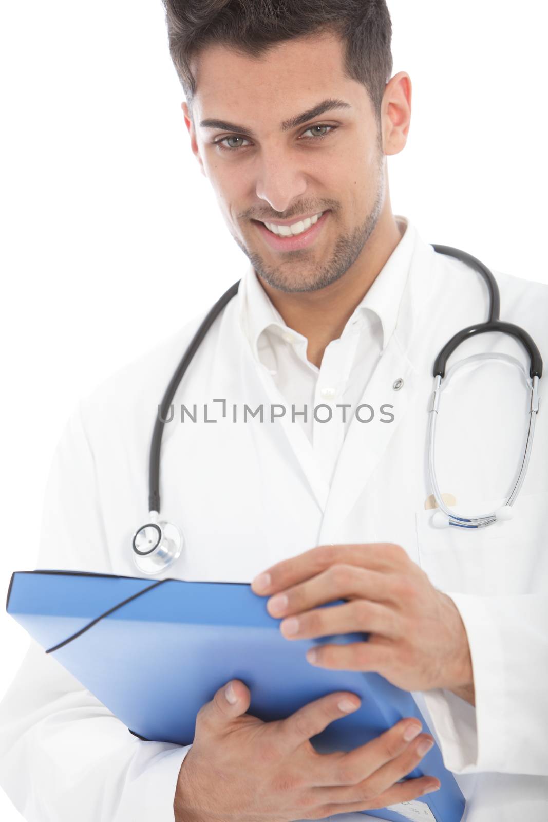 Young handsome male doctor in a white lab coat holding a patients file in his hands looking down at the camera isolated on white