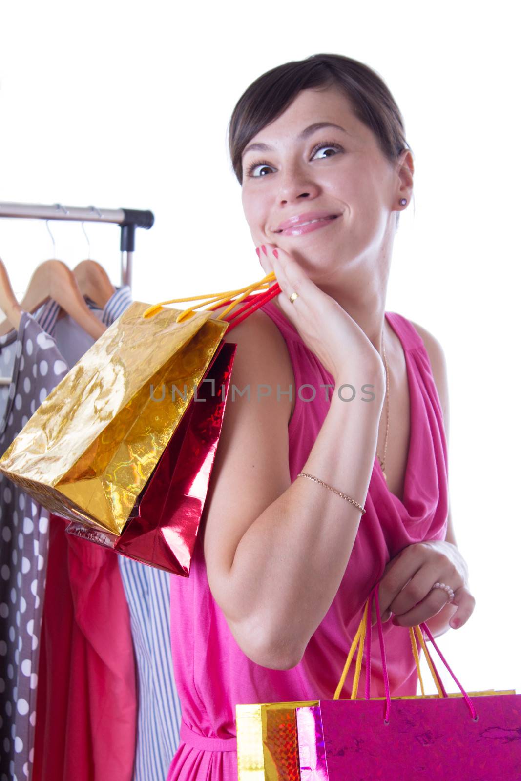 Amazed woman with shopping bags near hanger isolated on white