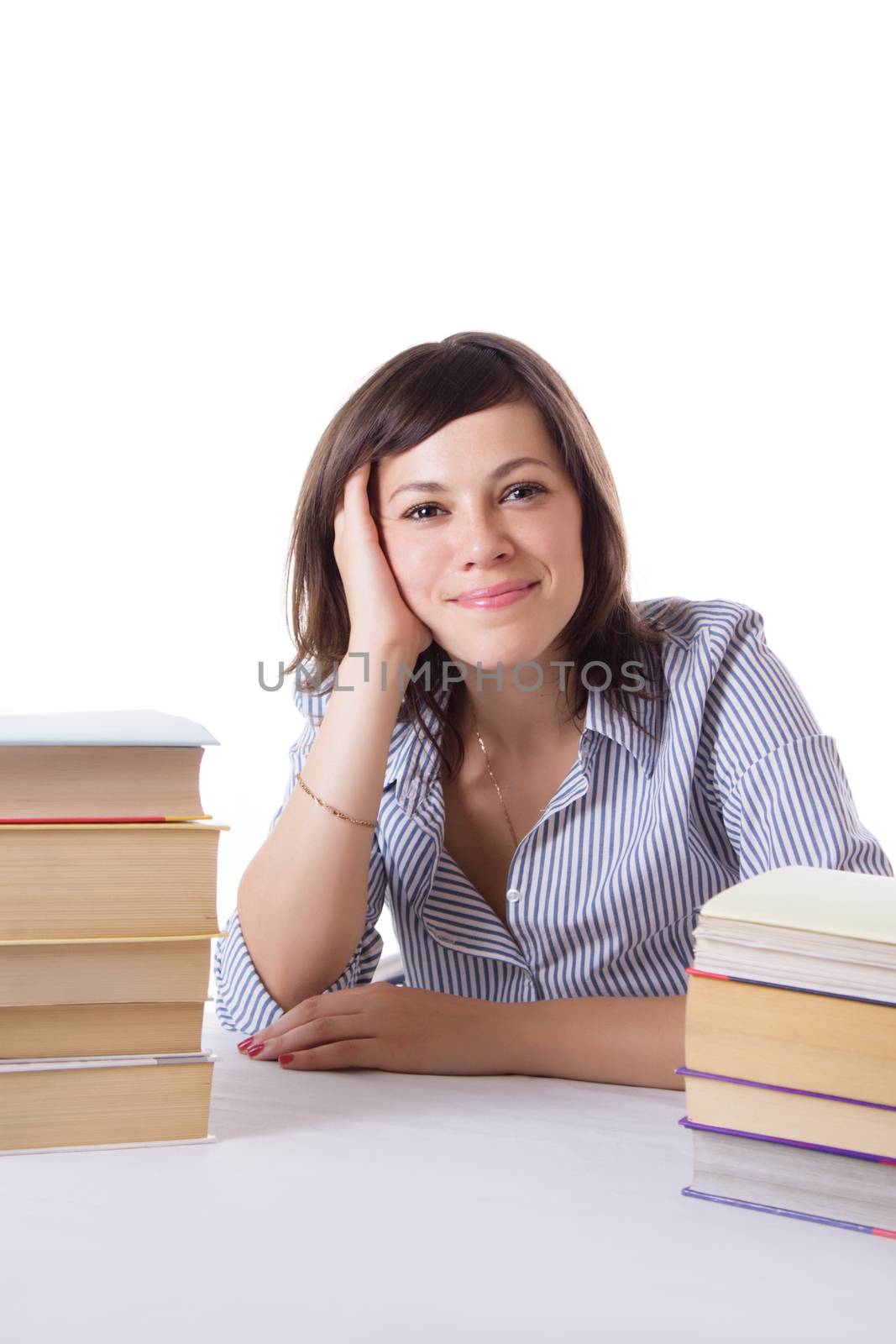 Smiling student girl sitting with pile of books isolated