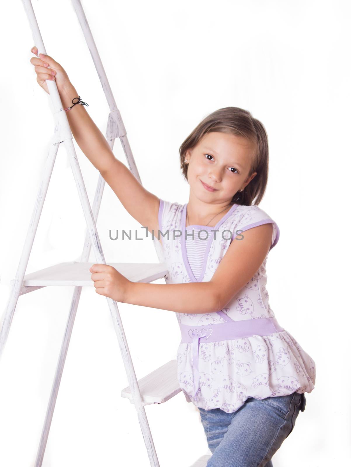 Cute smiling girl sitting on steps isolated over white