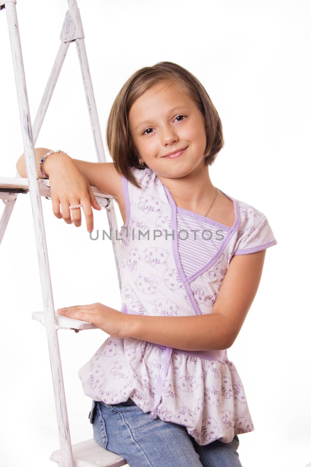 Cute smiling girl sitting on steps over white