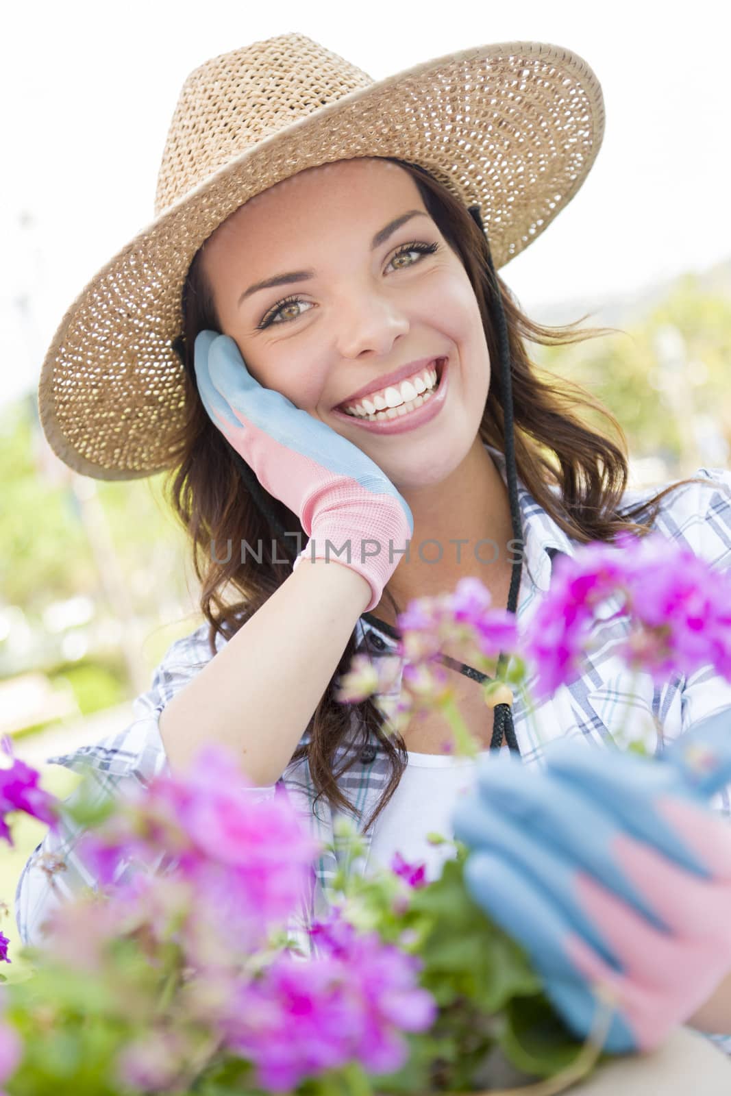 Attractive Happy Young Adult Woman Wearing Hat Gardening Outdoors.