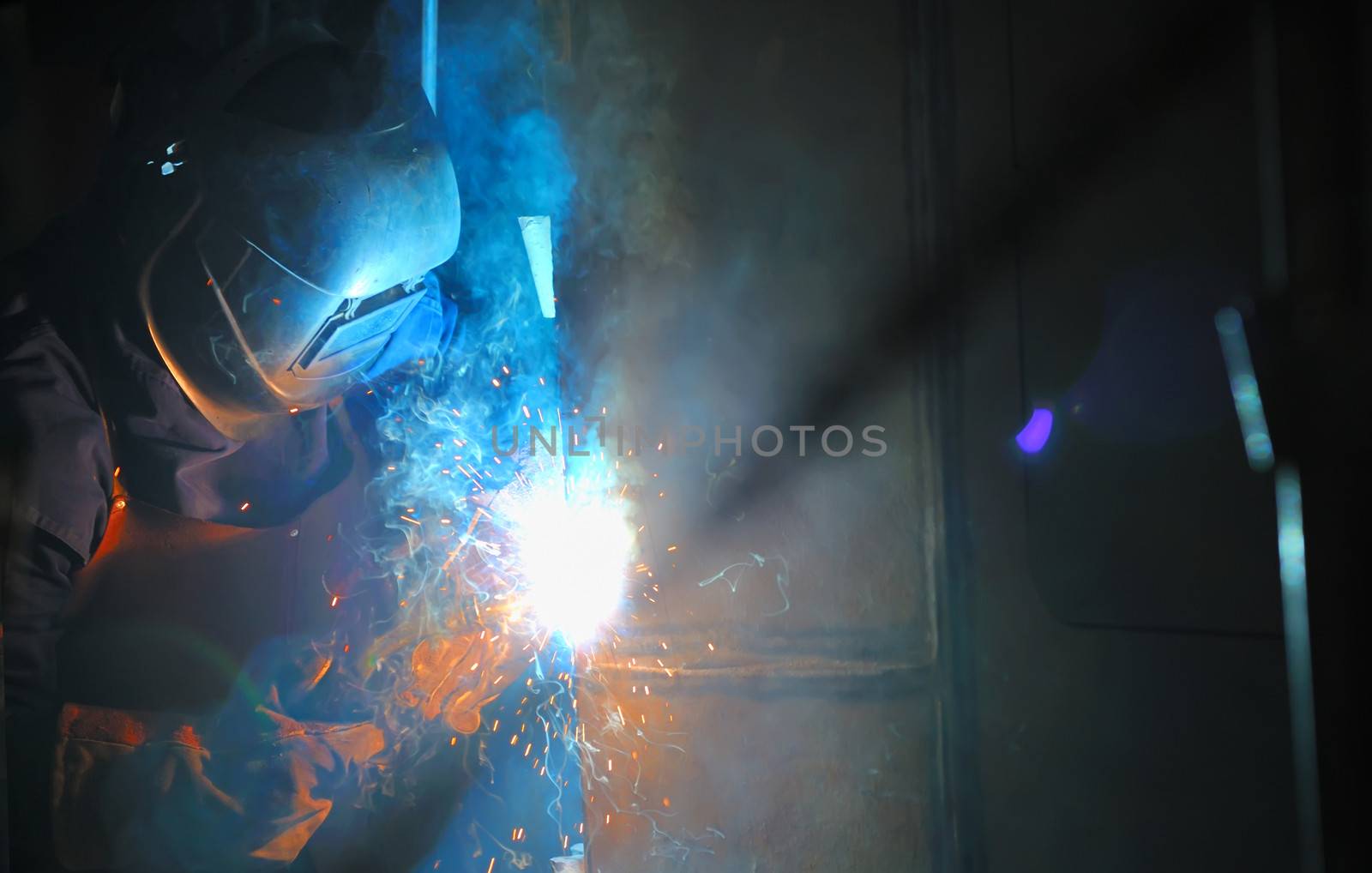 Industrial worker welding in factory by mady70