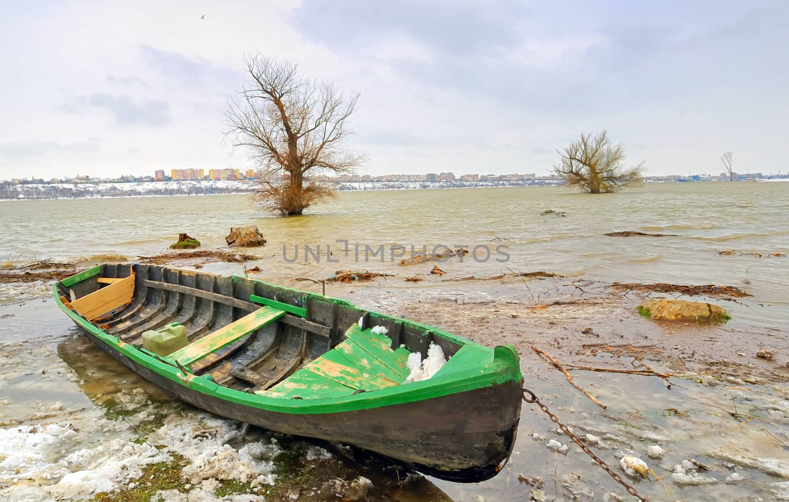 green boat on danube river in winter