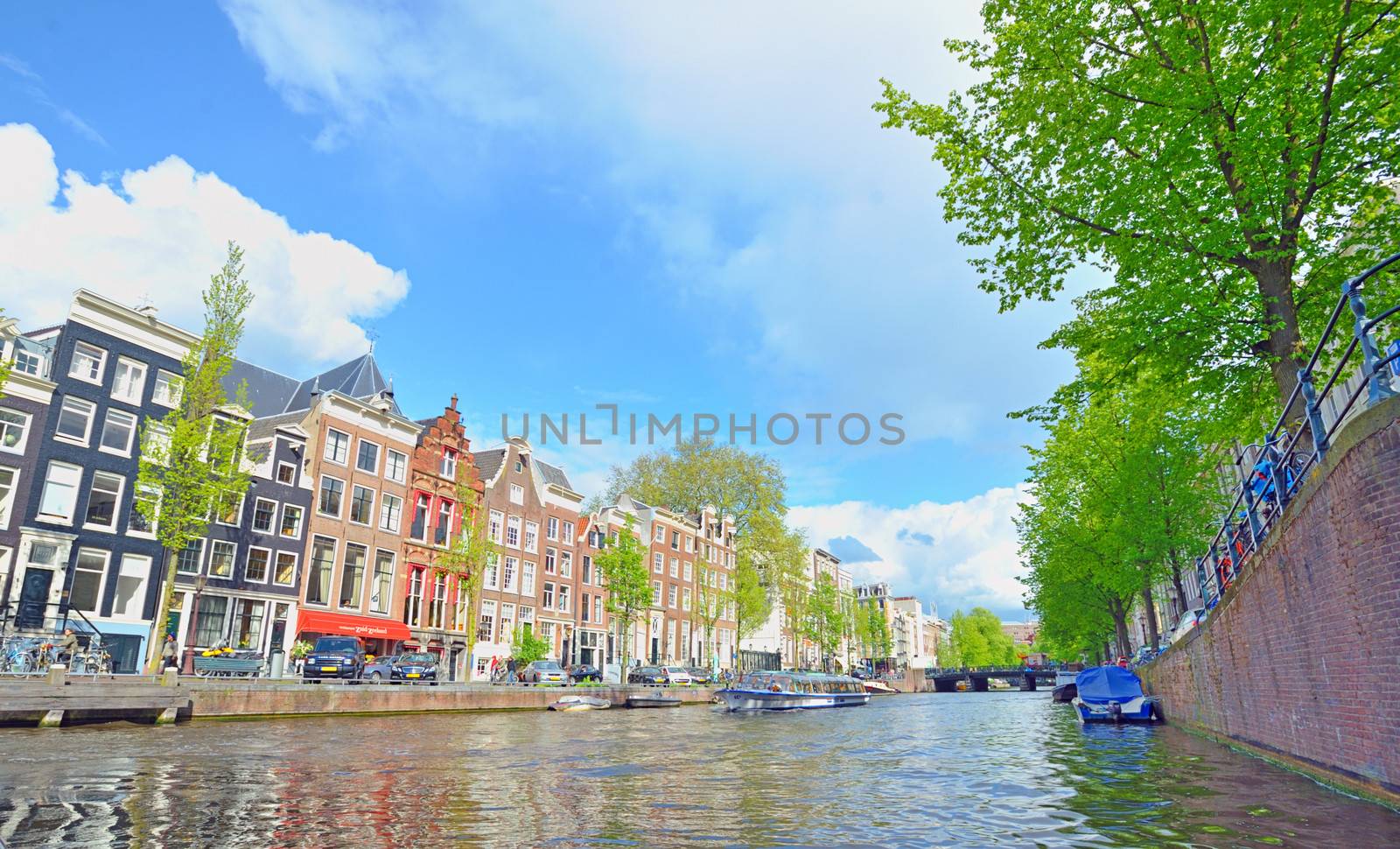 Traditional Houses and house boat along canal in Amsterdam, Holland