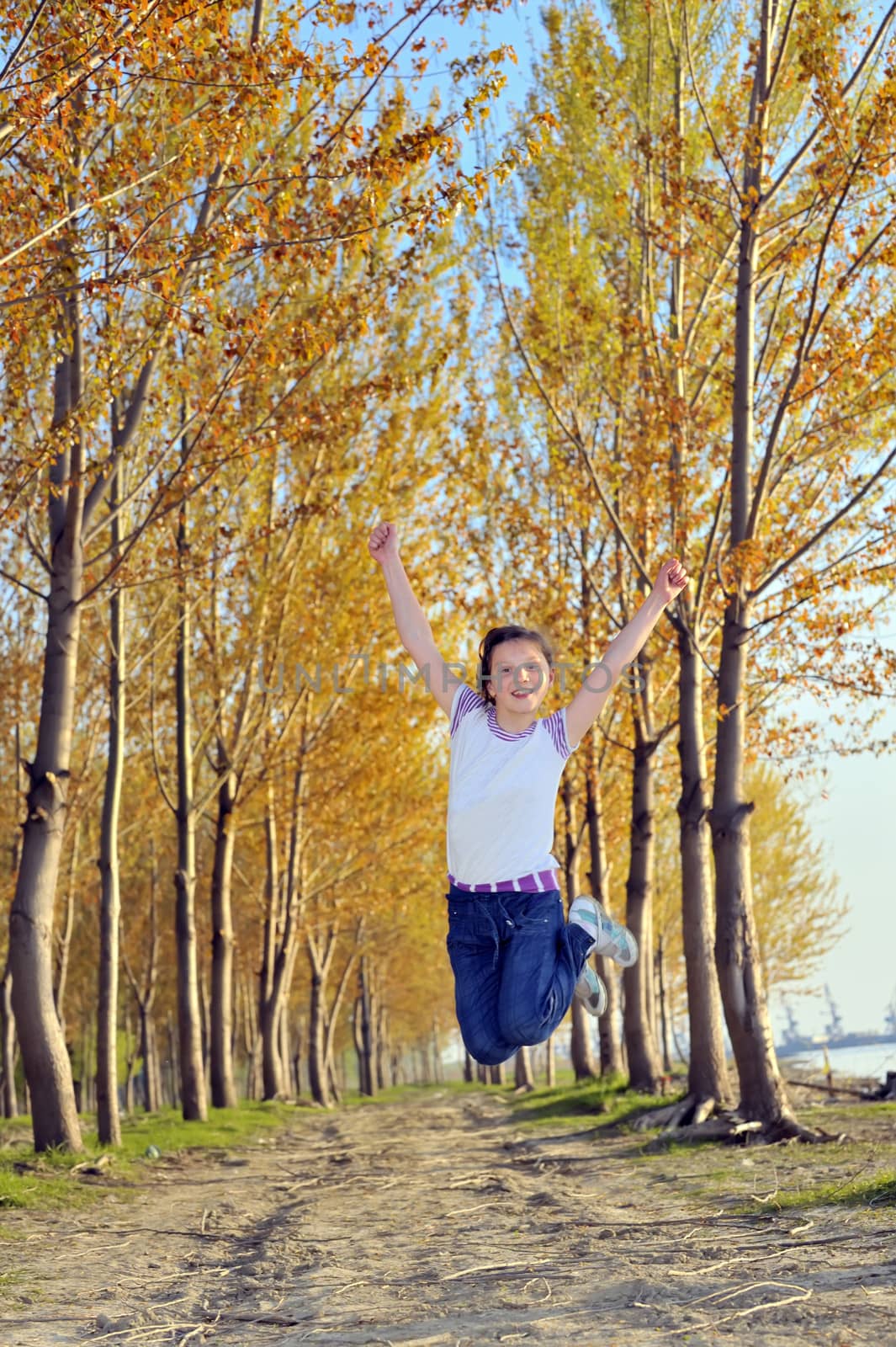 happy girl jumping in forest