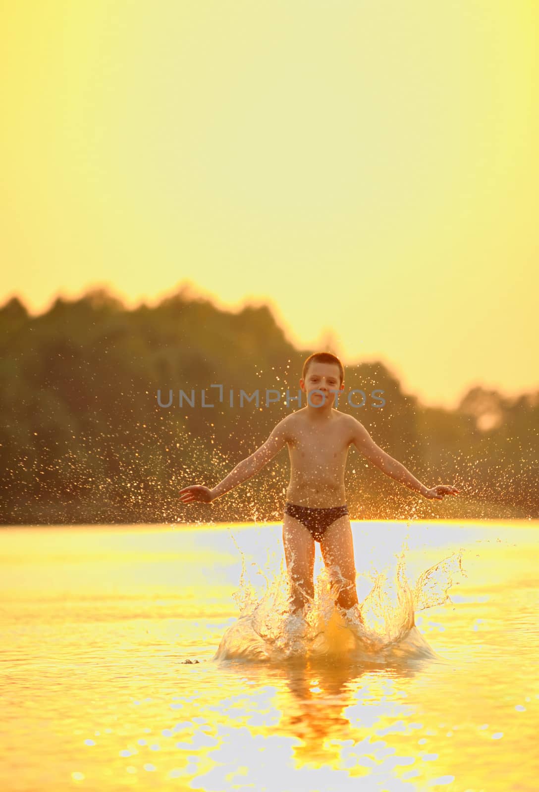 boy jumping in river by mady70