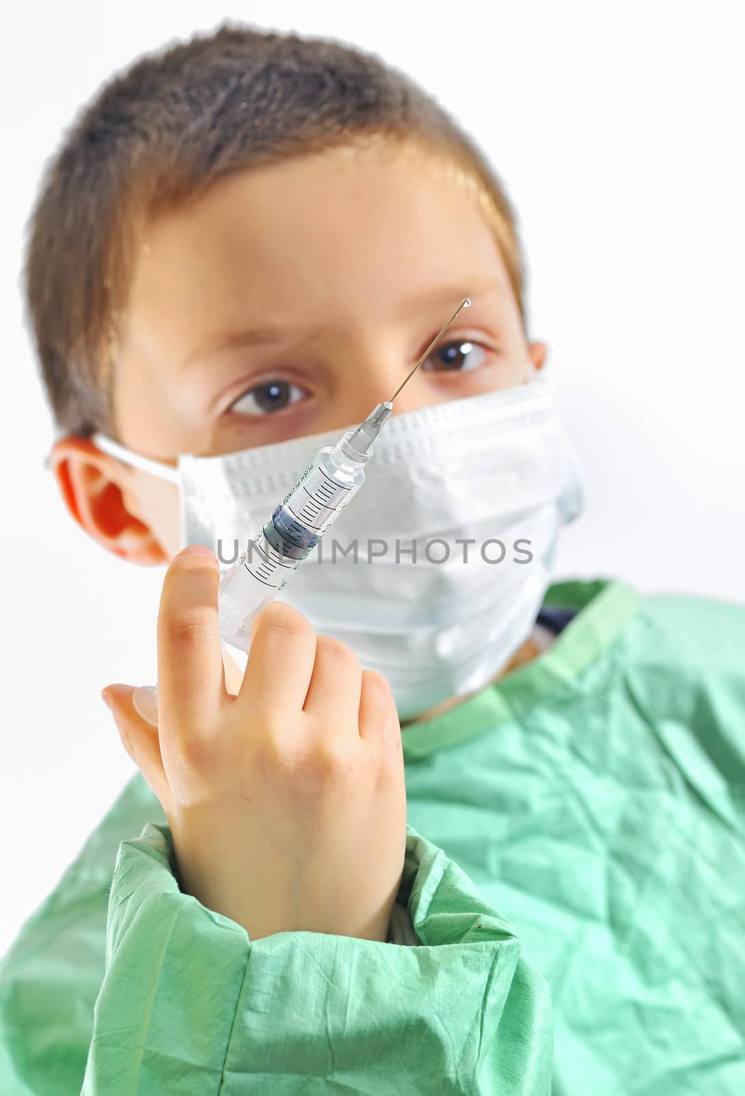 doctor boy with protective mask preparing to inject  by mady70