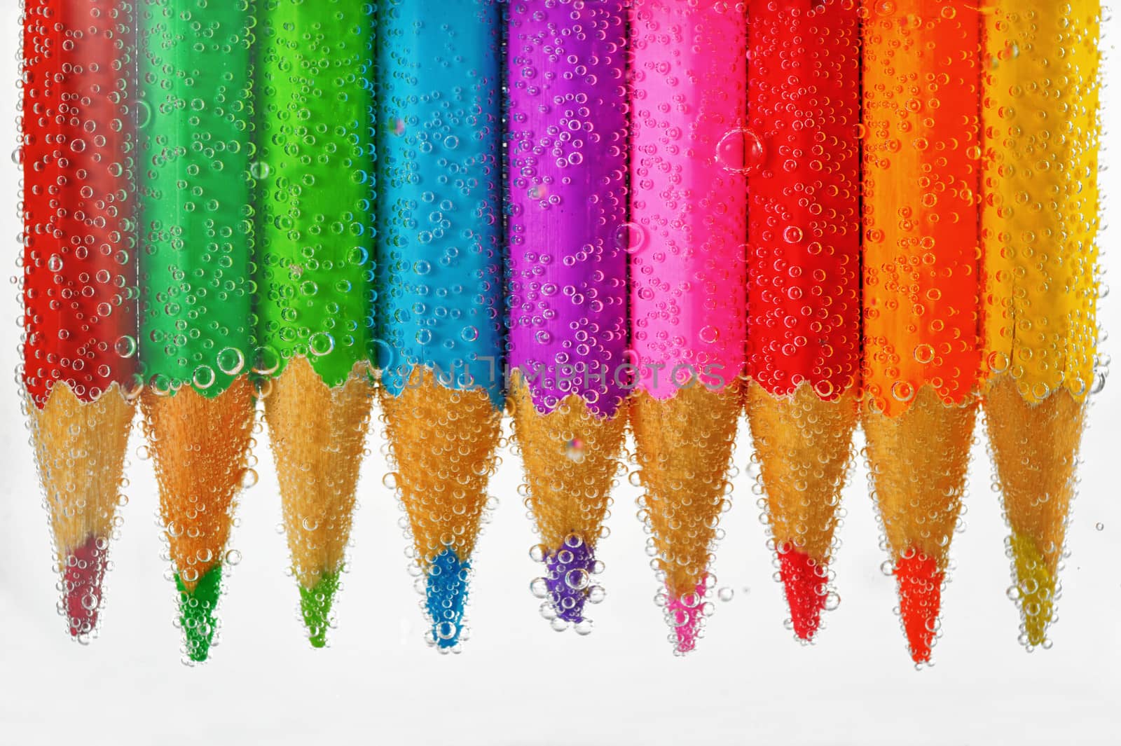 colored pencils sunken in water