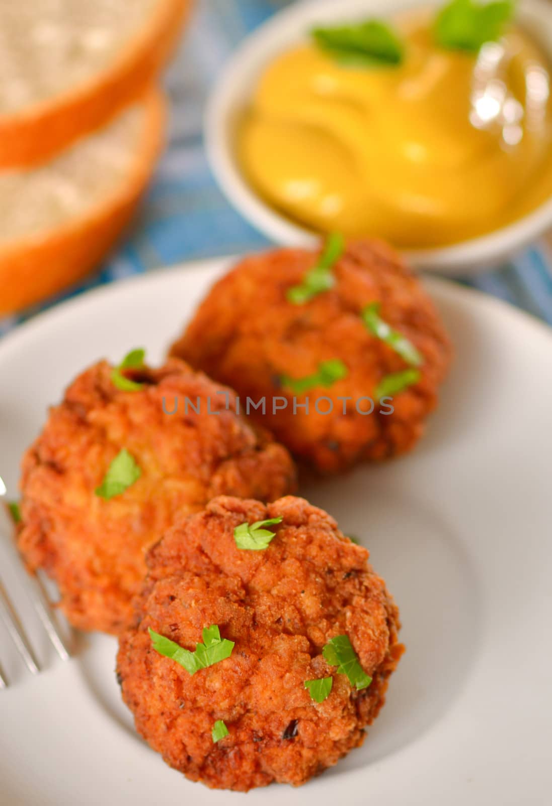 meat balls with mustard on white dish by mady70