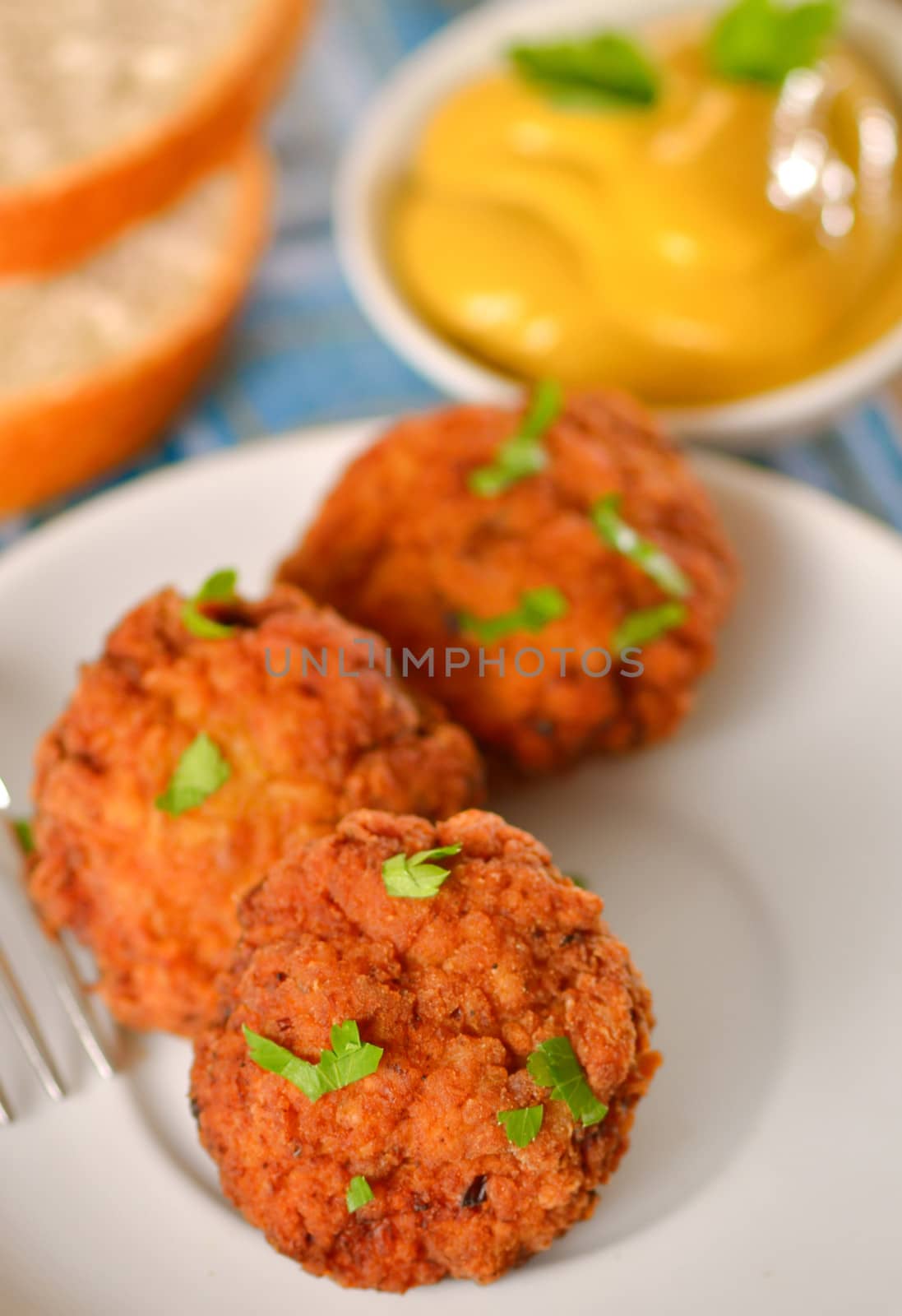 meat balls with mustard on white dish