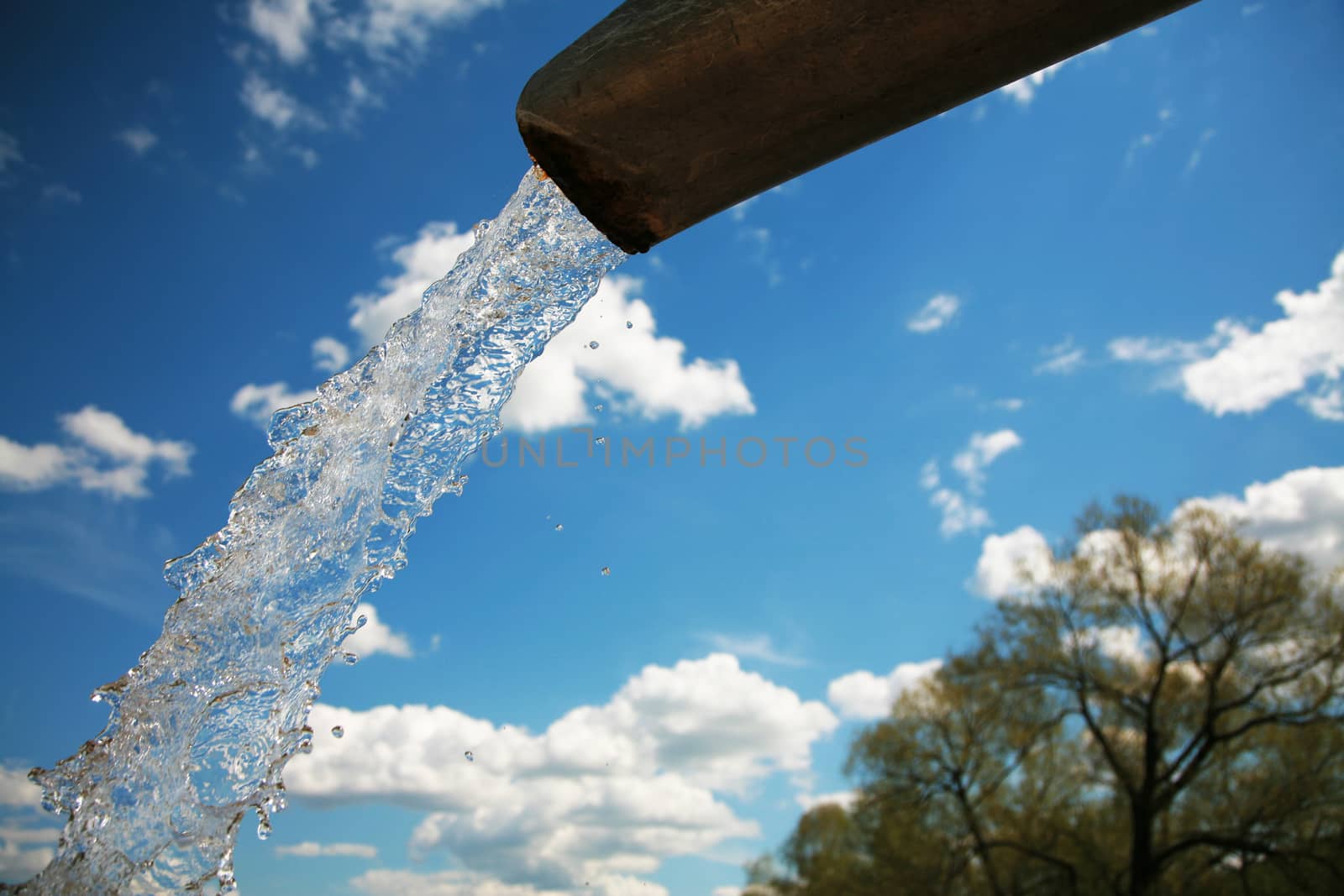 Pure water on a background of the blue sky