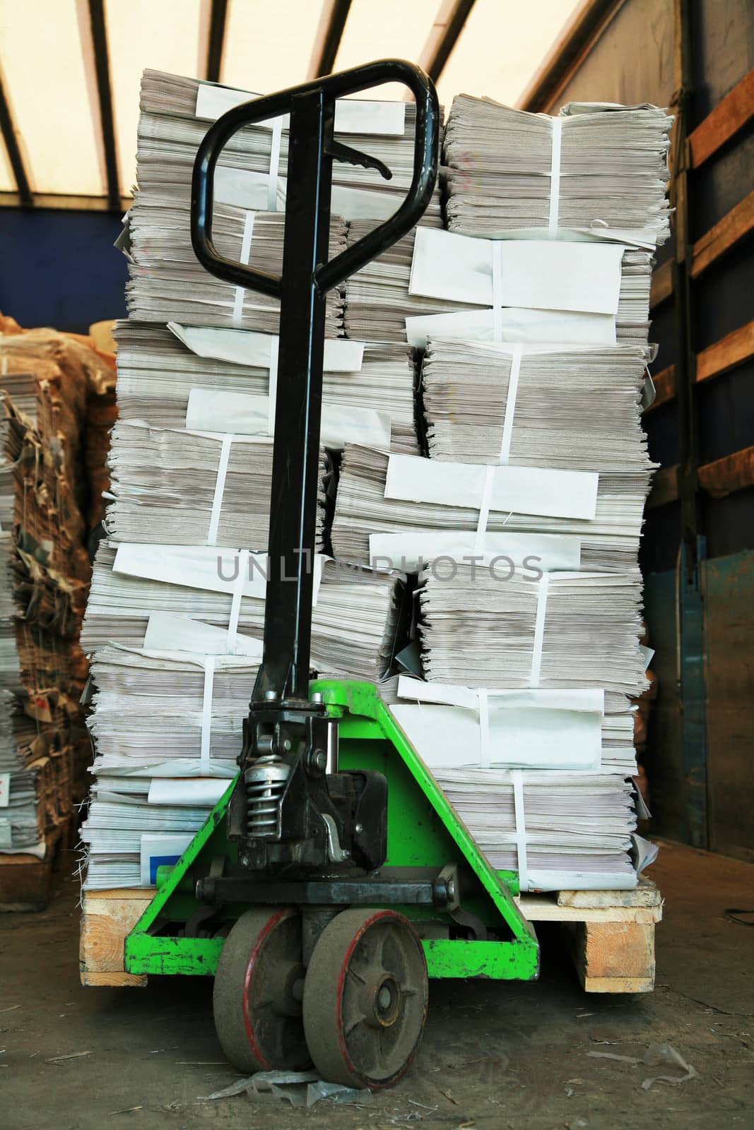 green manual carriage with a paper in a warehouse