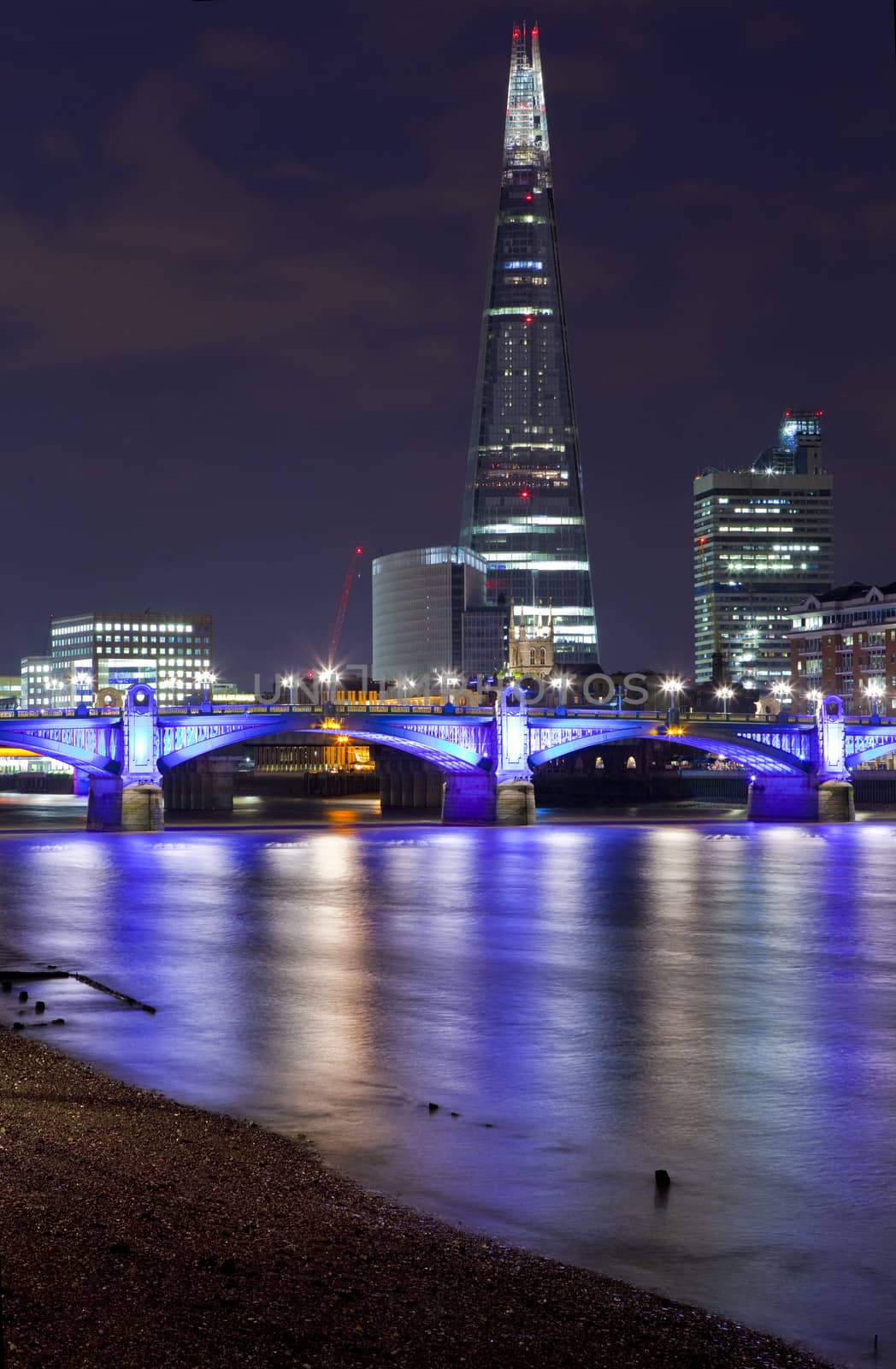 A view over the river Thames of the Shard and Southwark Bridge in London.