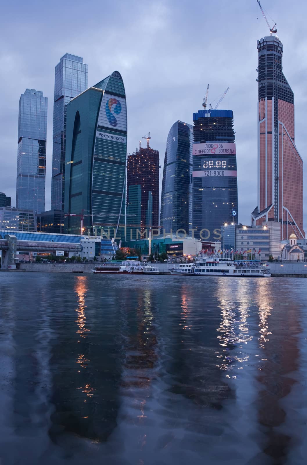 Business area Moscow City. Night view over the river. Nightfall