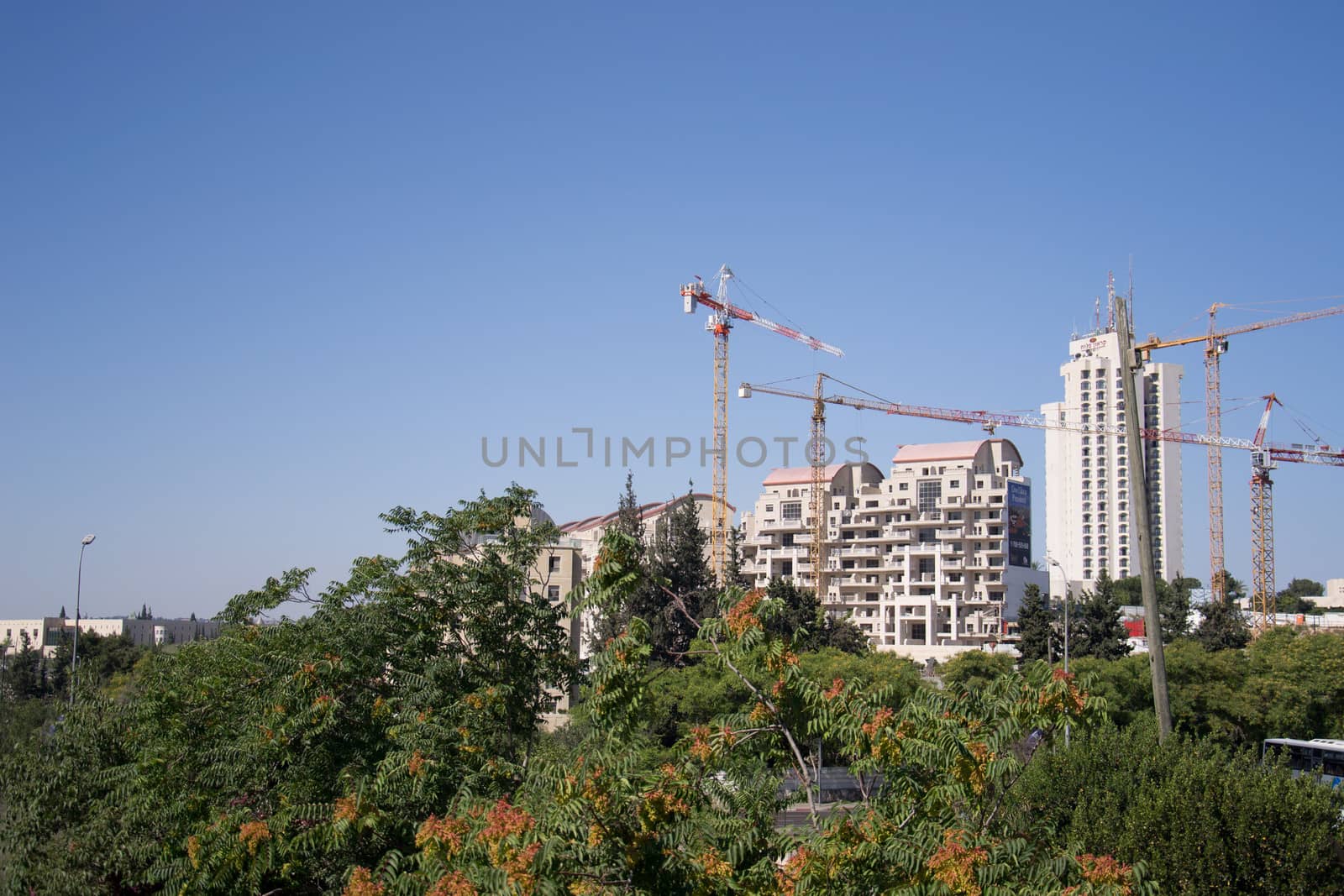 Construction cranes over new apartment buildings