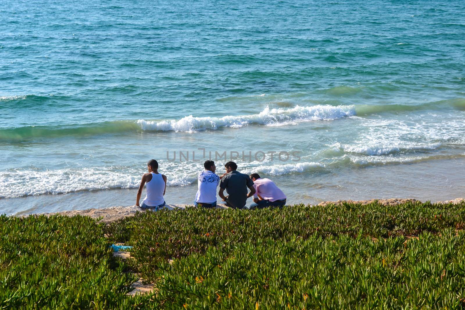 A group of friends talking at the beach in Tel Aviv