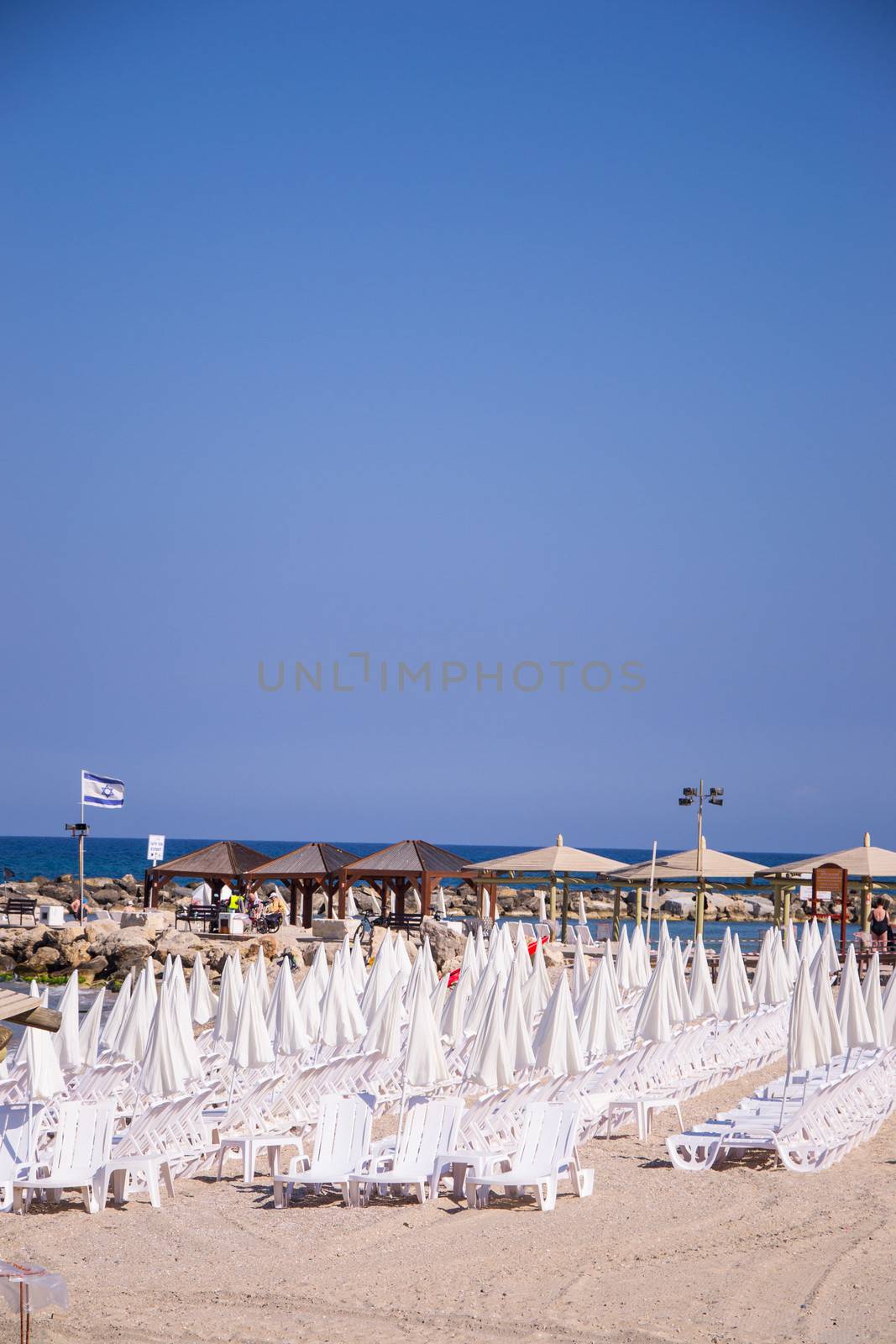  Beach umbrellas and sunbeds on the sand. by slavamalai