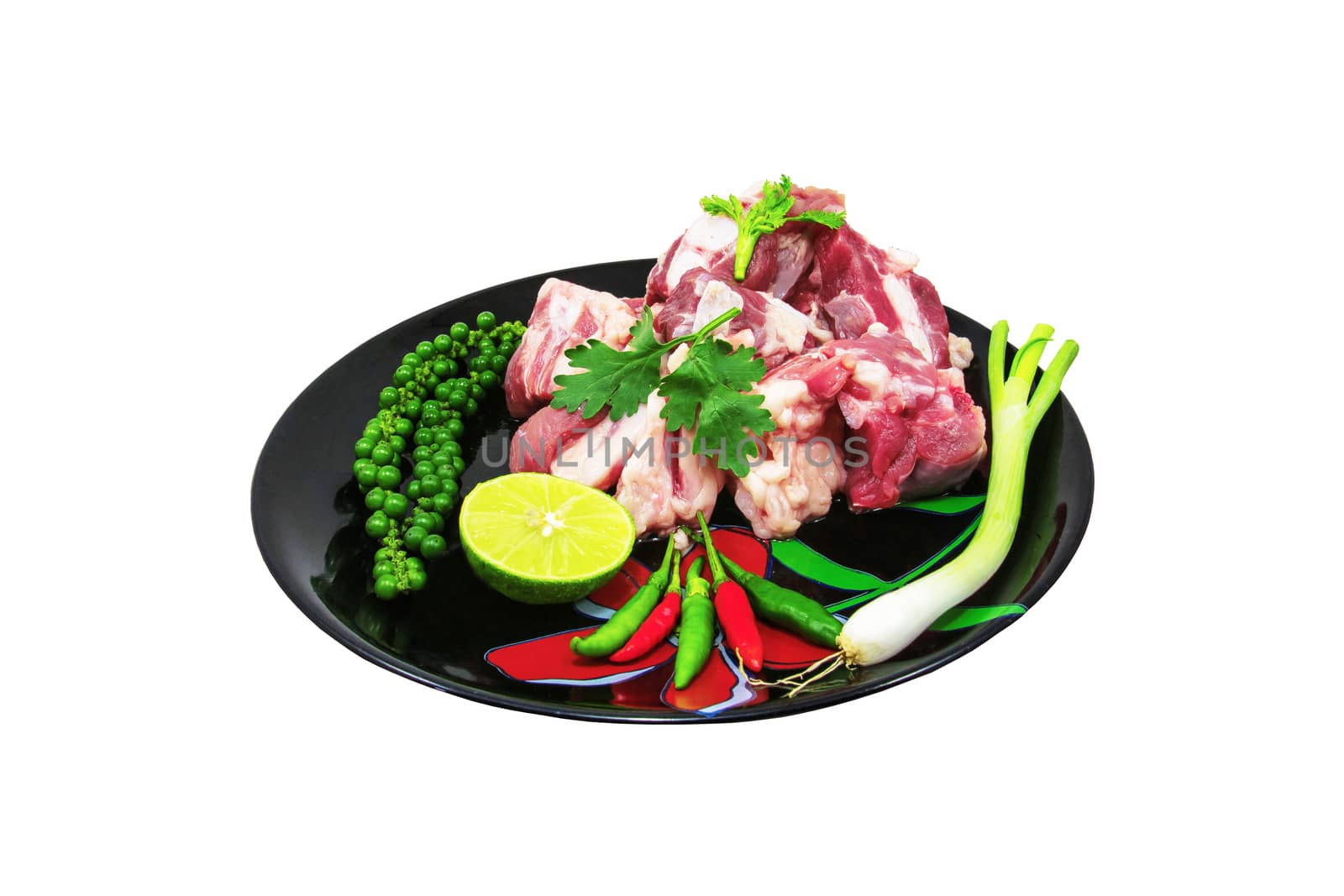 Raw pork ribs on a cutting board and vegetables by sutipp11