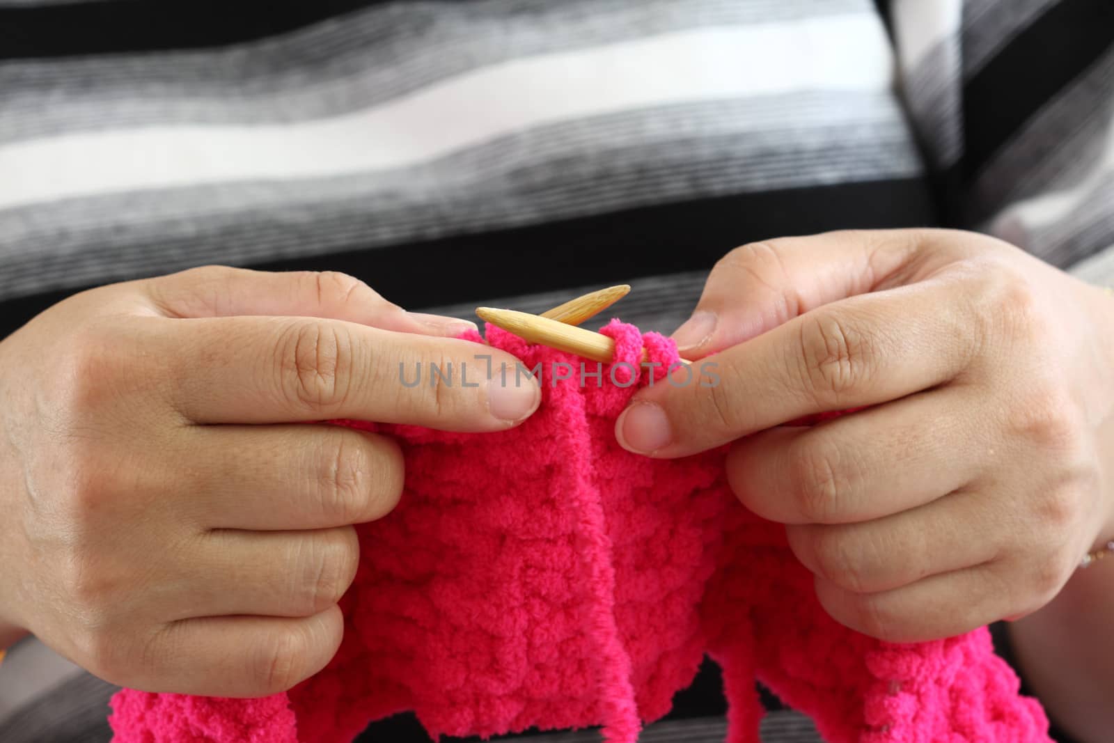 Hands of a young woman knitting