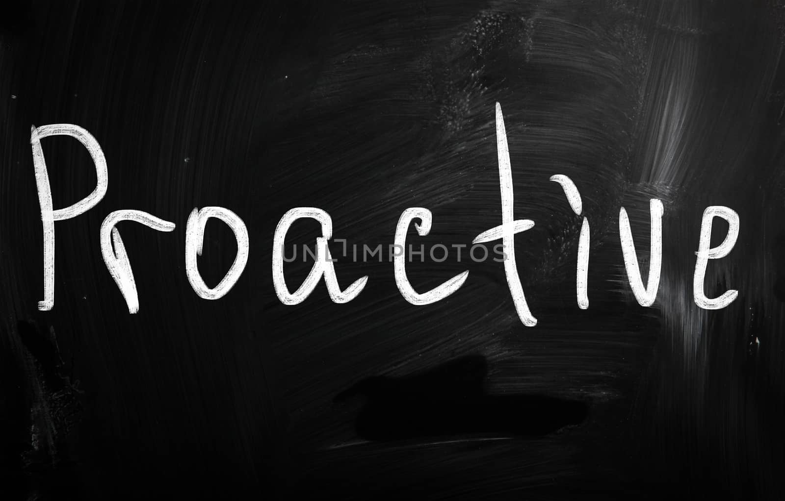 The word 'Proactive' handwritten with white chalk on a blackboard