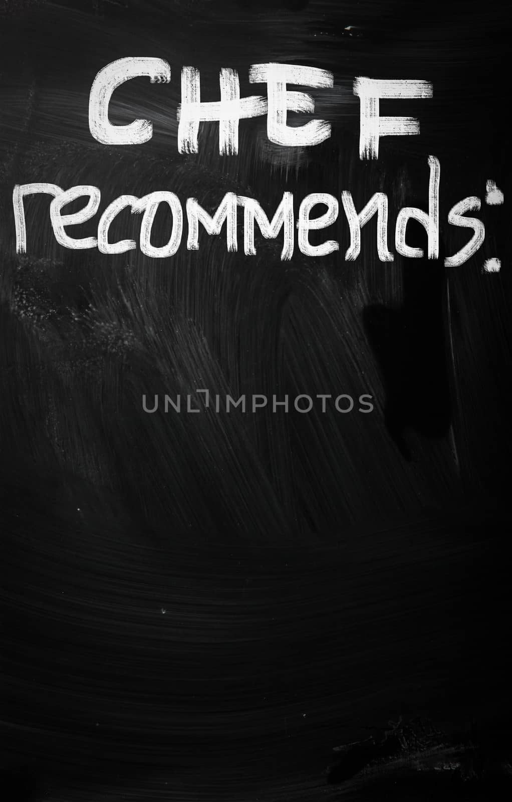 "Chef recommends" handwritten with white chalk on a blackboard by KrasimiraNevenova