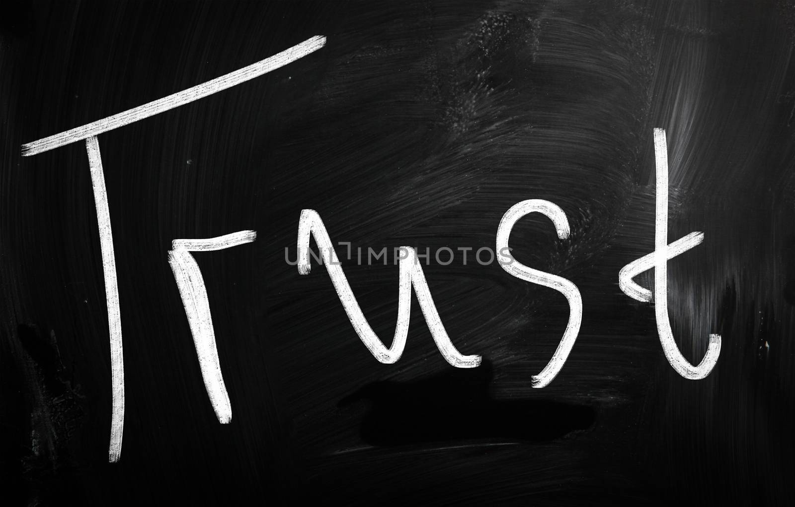 trust written with chalk on blackboard
