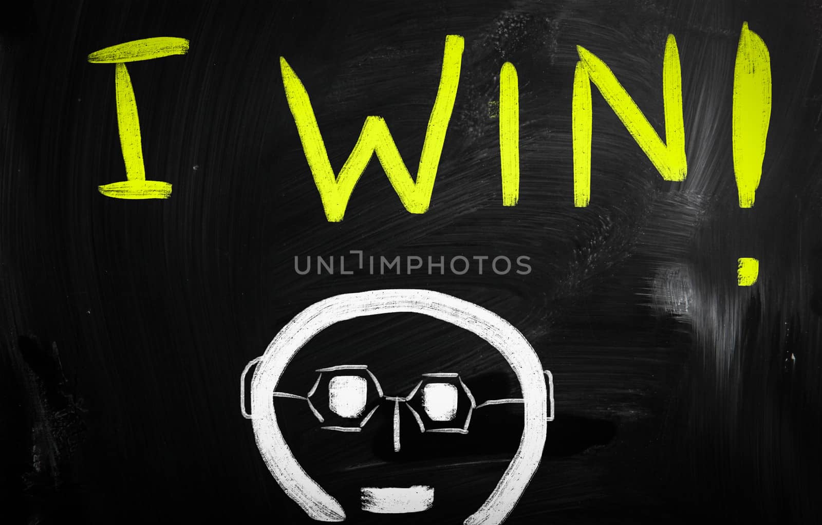 "Win" handwritten with white chalk on a blackboard