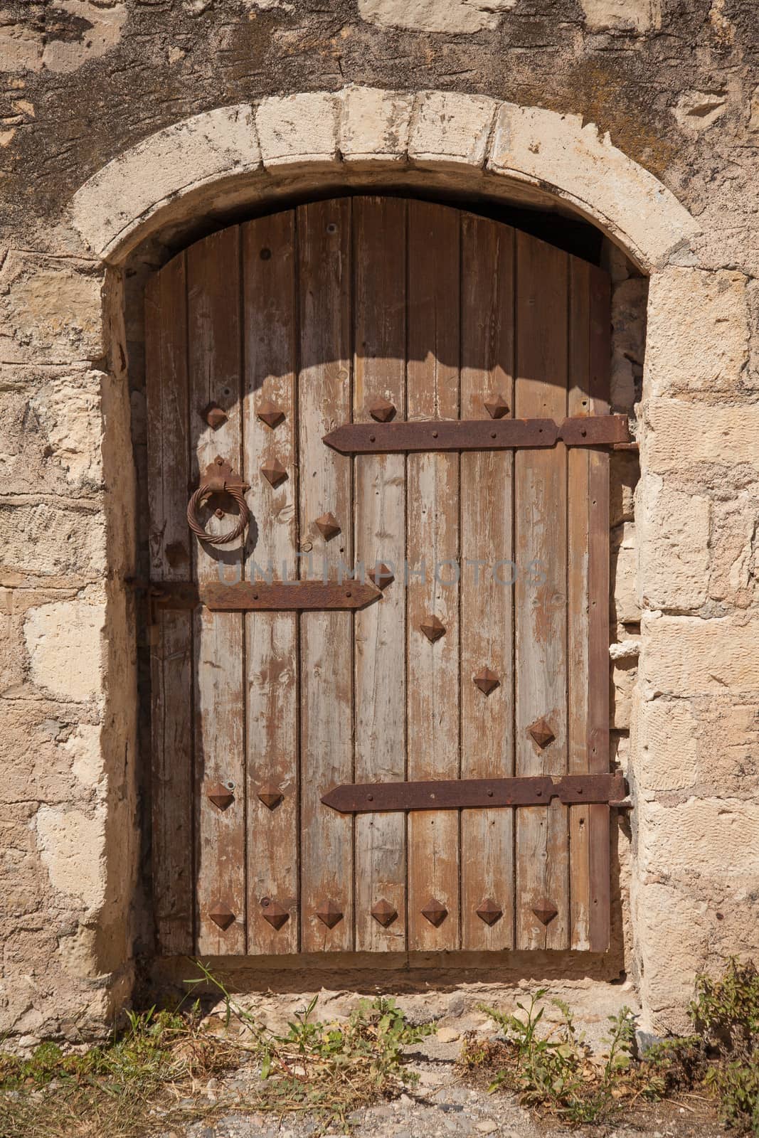Old wooden door with metal decor in monastery Touplu, Crete, Greece 