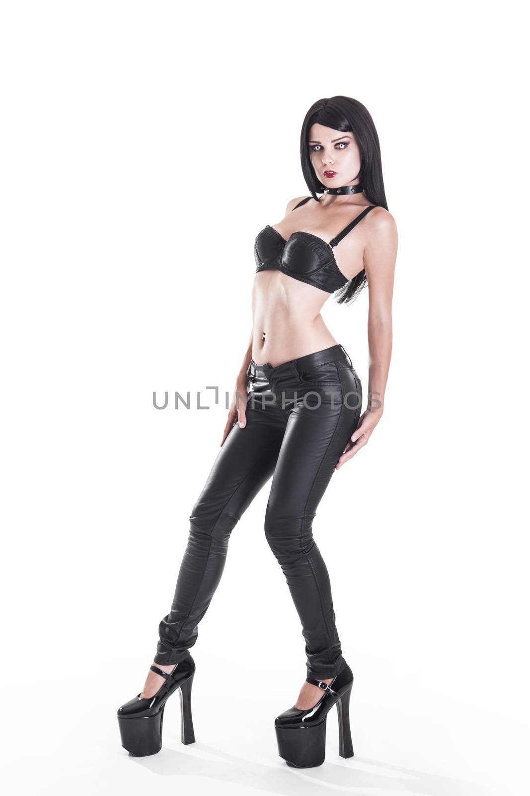 Sexy goth girl in leather pants, isolated on white background 