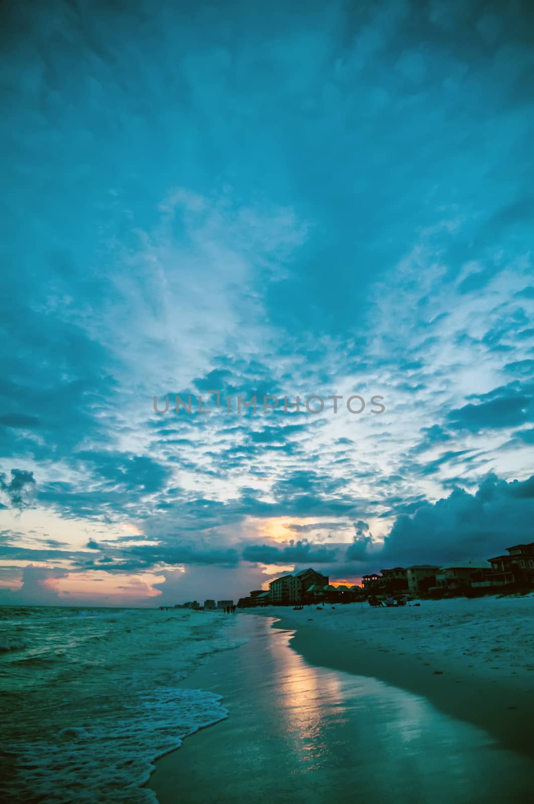 sunset on florida beach with white sand and blue sky