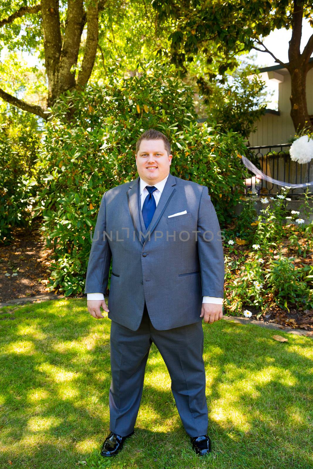 Portraits of a groom on his wedding day while waiting for his bride at a park outdoors in Oregon before the ceremony.