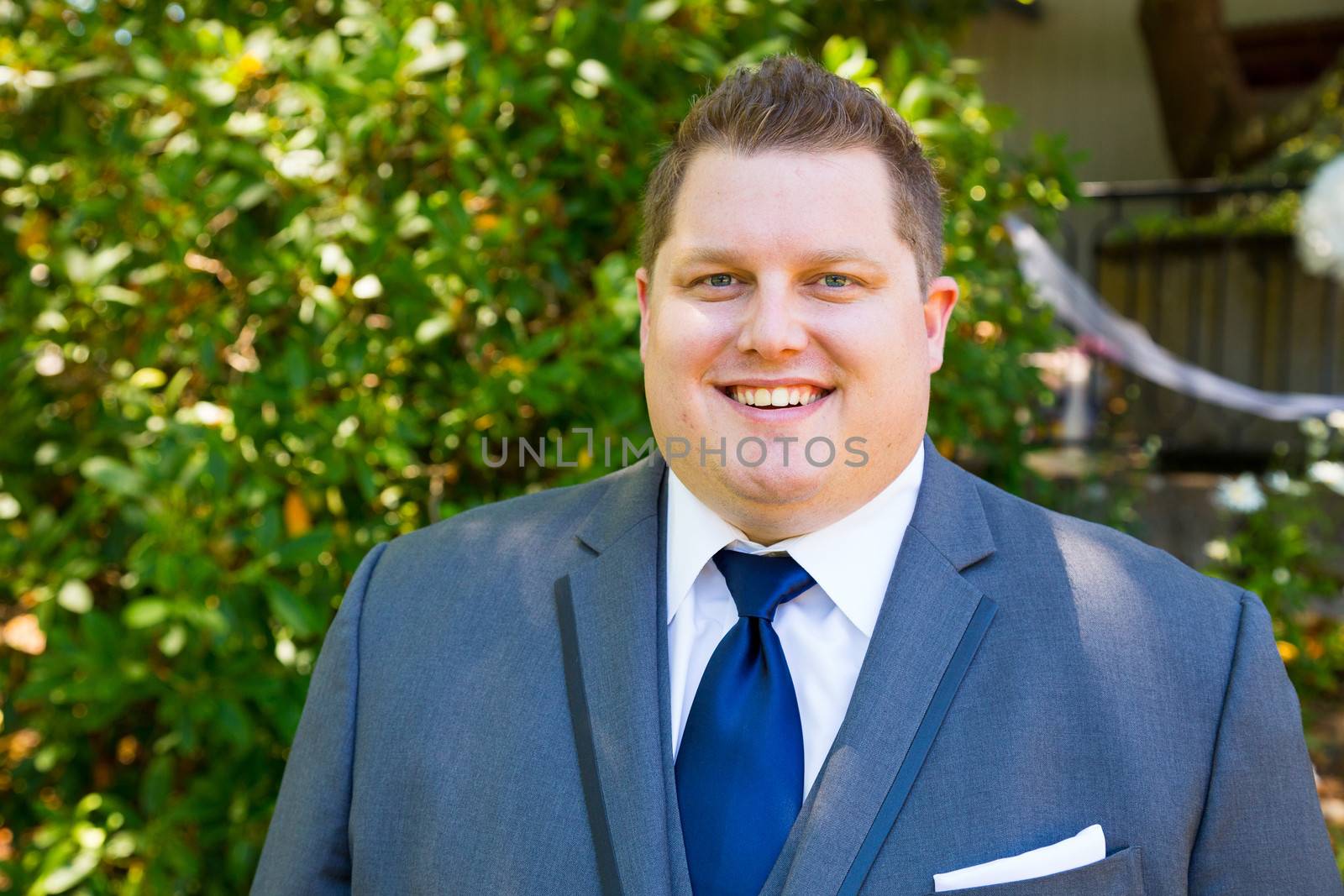 Portraits of a groom on his wedding day while waiting for his bride at a park outdoors in Oregon before the ceremony.