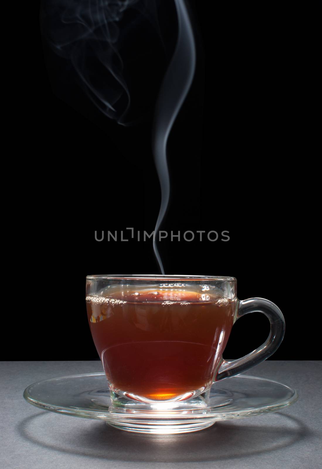 Hot tea in a glass cup with handle 