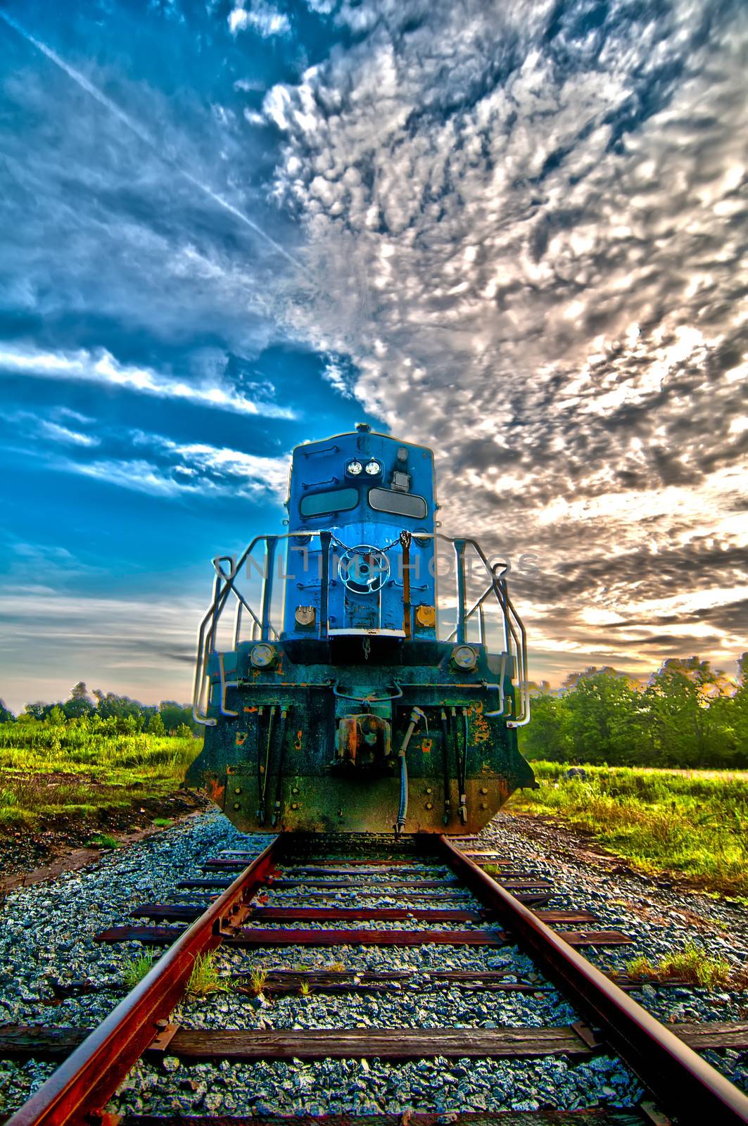 blue freight train engine at sunrise