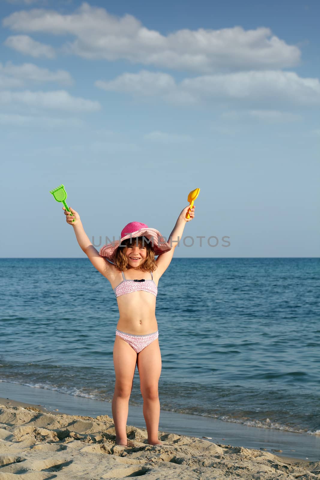 happy little girl on beach summer scene