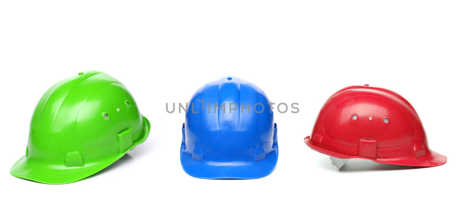 Blue, green, red hard hats isolated on a white background