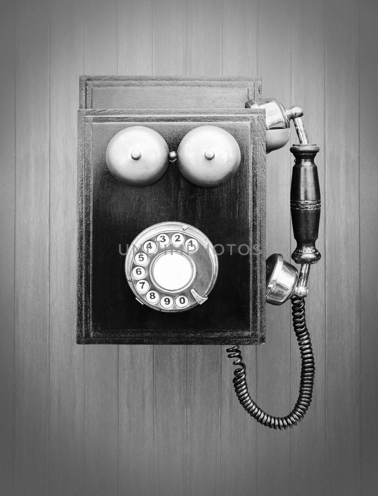 Vintage telephone over wood stripe wallpaper baground