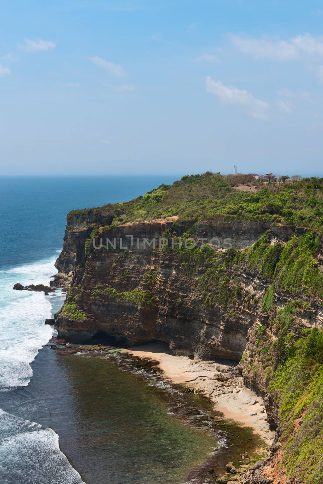 Cliffs above blue tropical sea by iryna_rasko