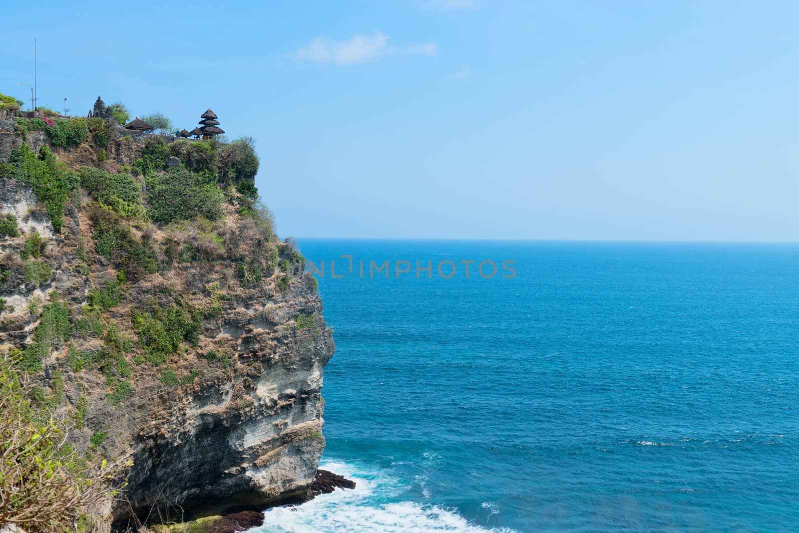 Pura Luhur Uluwatu Temple, Bali on high cliffs above blue tropical sea