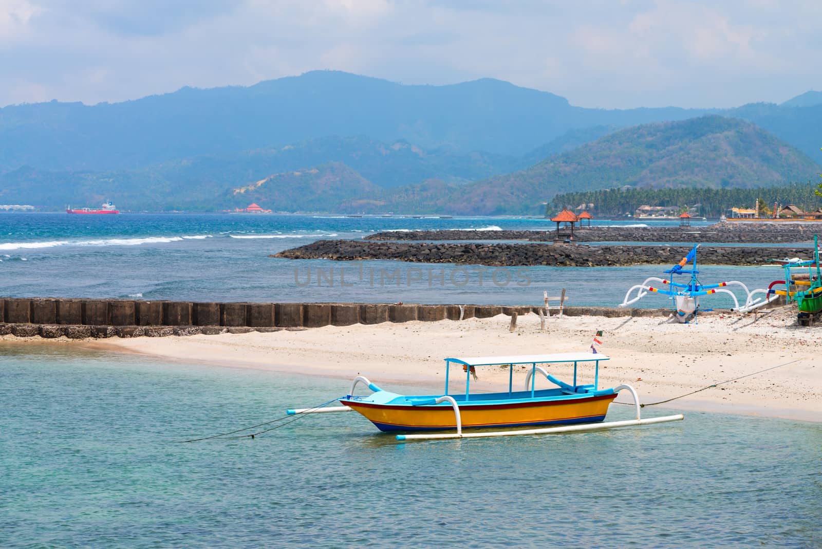 Traditional fishing boats on a beach in Candidasa on Bali, Indonesia. 