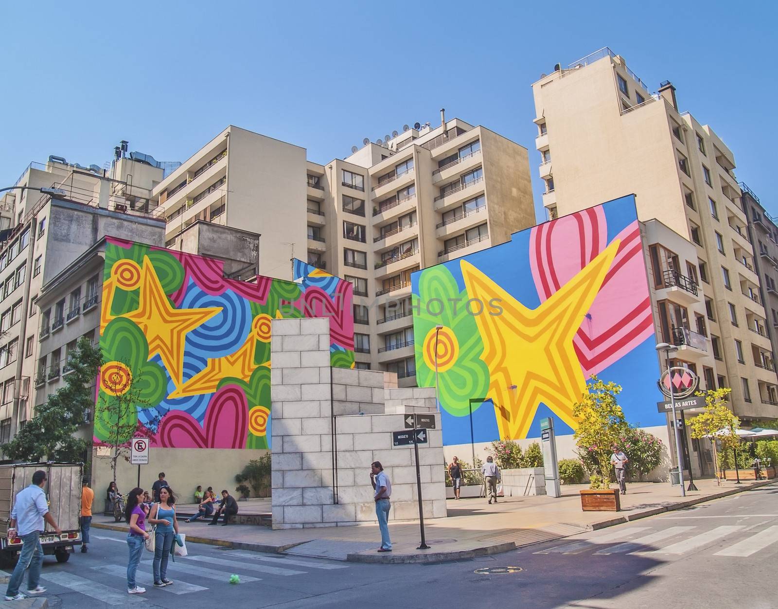 Santiago, February 2011. Street on downtown with colorful graffiti and people walking and standing. 5.5 million population in Santiago.