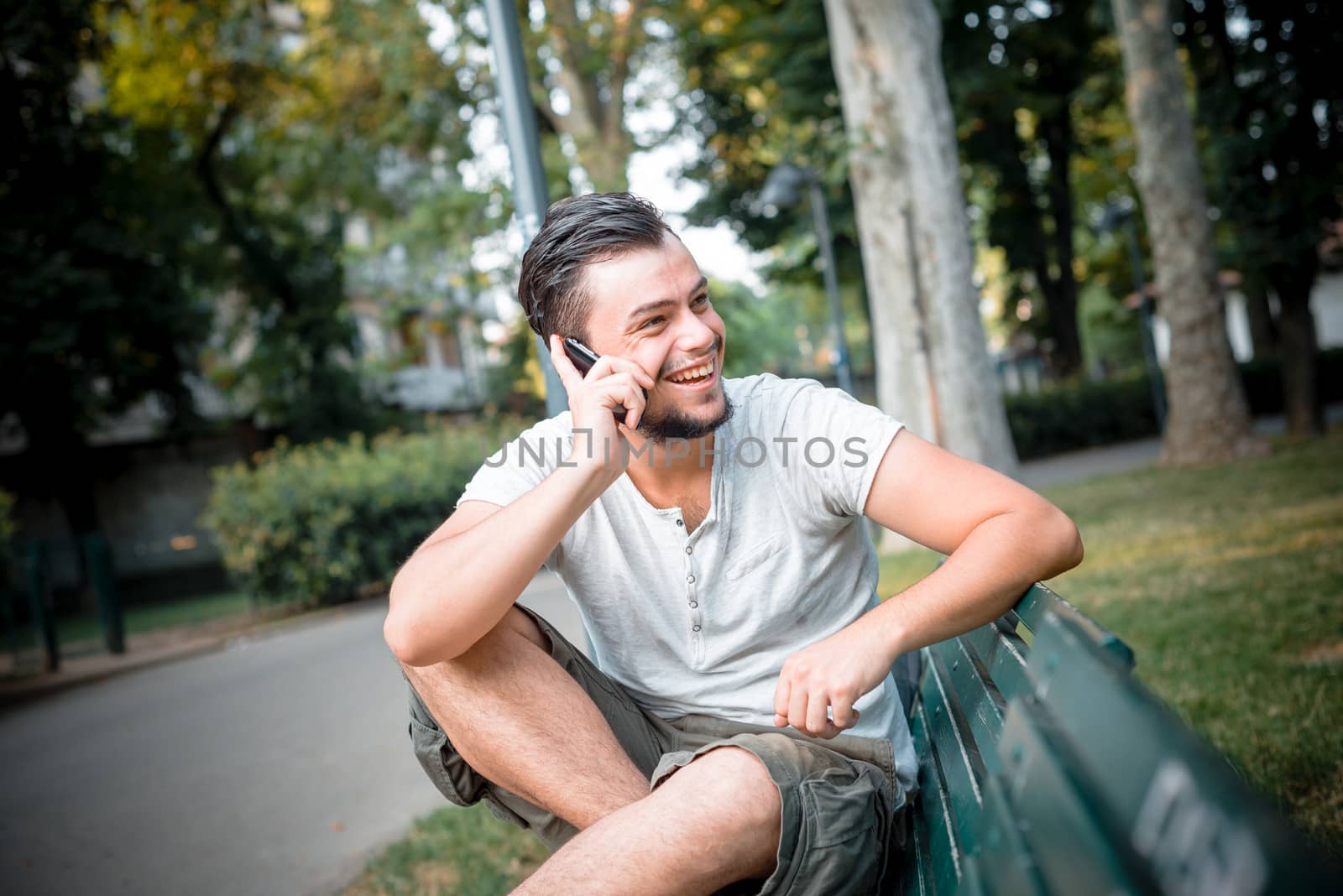 stylish man on the phone at the park