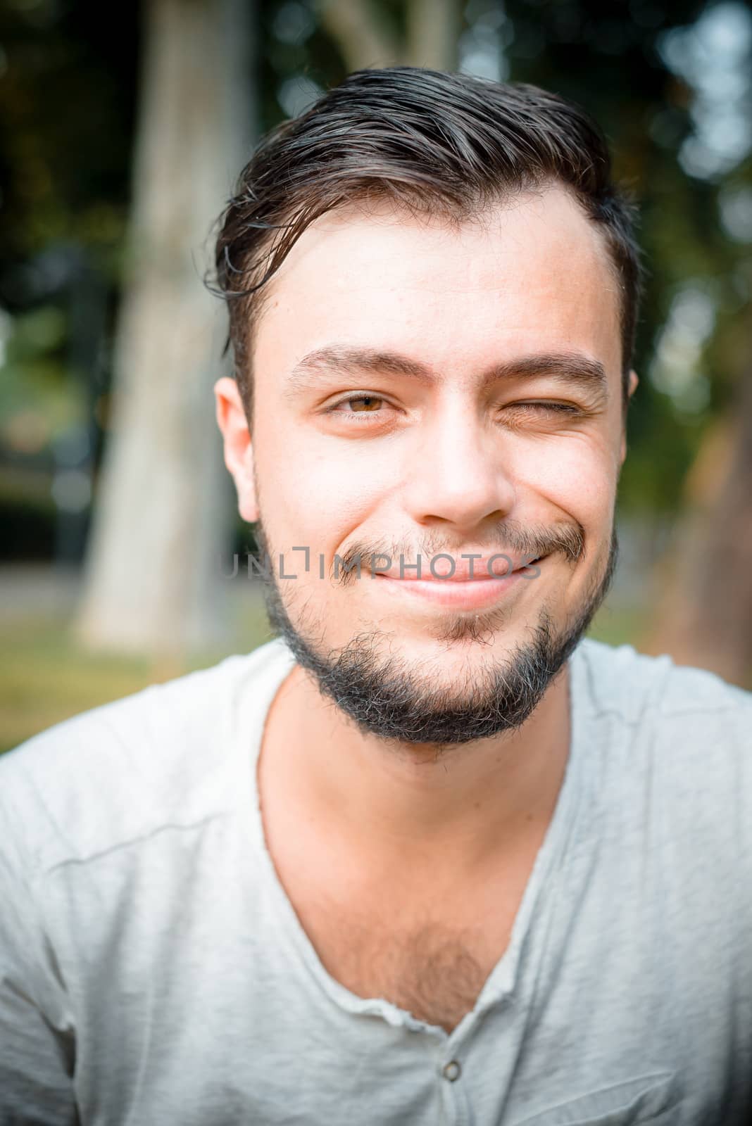 close up portrait of youg stylish man winking