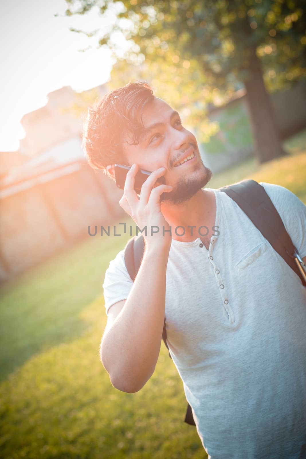 stylish man on the phone at the park