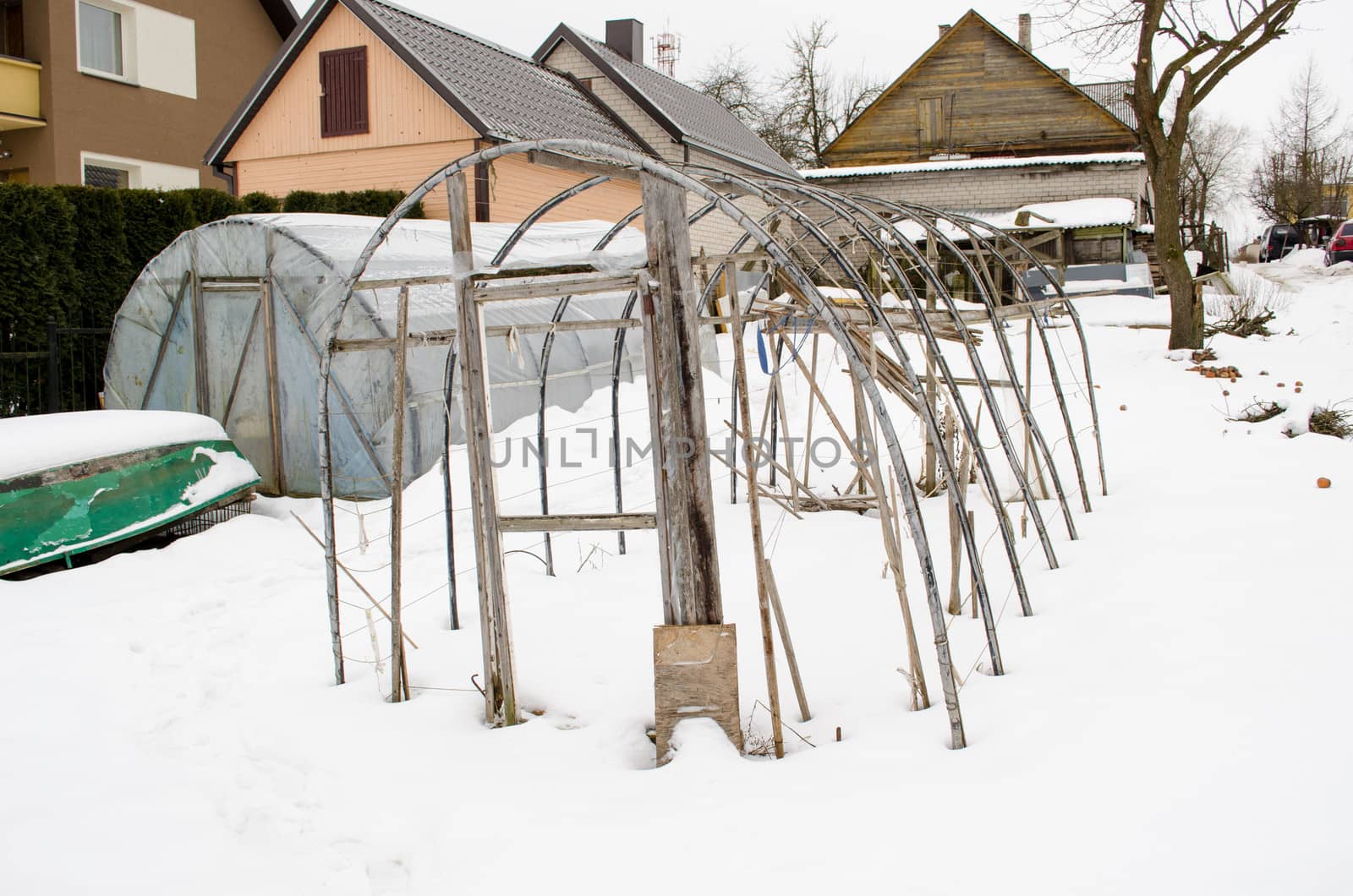 closeup of polythene handmade diy greenhouse conservatory construction in winter season garden yard.